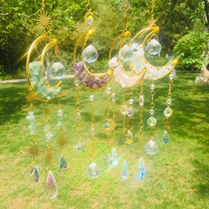 Outdoor suncatcher showing four moon crystal ornaments with stones and rainbow prisms