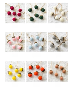 Set of colorful handmade wool felt acorns with natural caps for Christmas tree decoration
