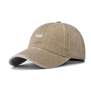 Detail of embroidered 'Chili' logo on khaki washed cotton baseball cap texture