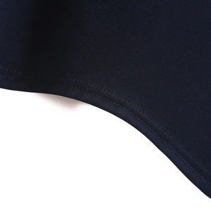 Detail of navy blue breathable knit fabric with durable double-needle stitching on hem