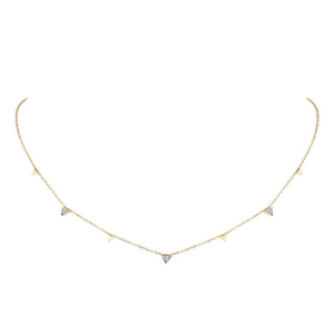Detailed view of gold plated necklace with triangular zircon pendants on a white background