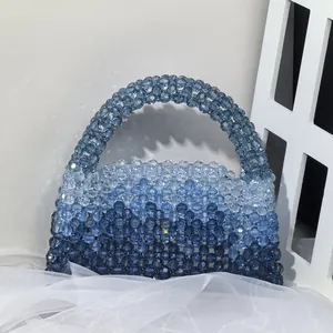 Detail of blue gradient beaded handbag showing handmade woven crystal beads and craftsmanship