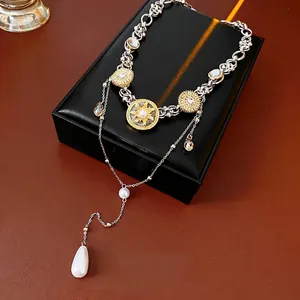 Luxurious layered two-tone necklace with pearl and crystal teardrop pendants
