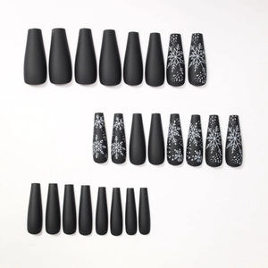 Matte black artificial nails with white snowflake patterns in a 24-piece full set