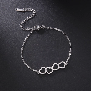 Macro shot of stainless steel bracelet featuring four linked open heart charms with clasp