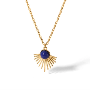 Macro view of golden sunflower pendant with center round blue lapis lazuli stone