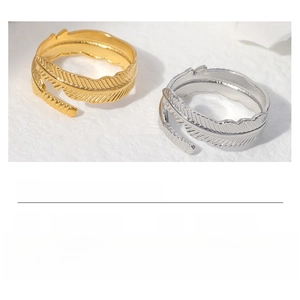 Detailed view of adjustable stainless steel feather rings in gold and silver finishes