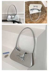 Detailed views of a silver baguette bag with bow decoration and metallic luster finish