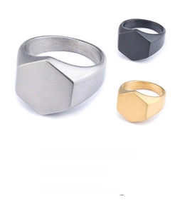Detail view of hexagonal brushed metal signet rings in silver black and gold colors