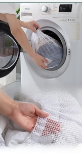 Close-up of white mesh laundry bag showing coarse texture and drawstring closure detail