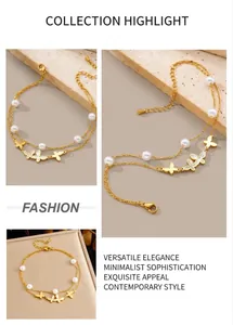 Detail of double-layer gold anklet with butterfly charms and white pearls on stone surface