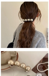 Detail of elegant rectangular pearl hair clip on ponytail and decorative accessories
