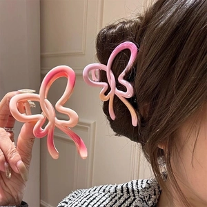 Large pink gradient bow hair claw clips for women showing two styling views