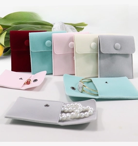 Detail of colorful velvet jewelry pouches with metal snap button for rings and necklaces