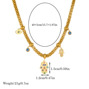Macro shot of gold Hamsa hand and evil eye charms on a beaded chain with size details