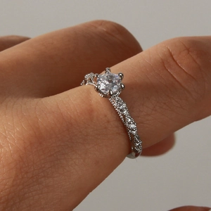 Elegant silver hollow relief ring with vintage six-claw setting and sparkling zircons