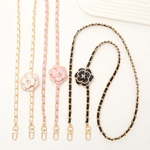 Three leather chain straps with camellia charms in white, pink, and black colors