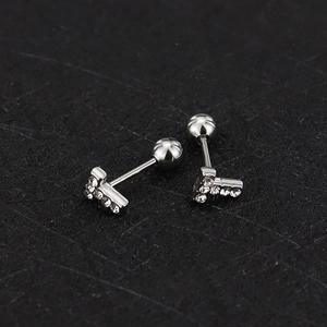 Macro detail of silver screw-back stud earrings with pave-set zircon stones