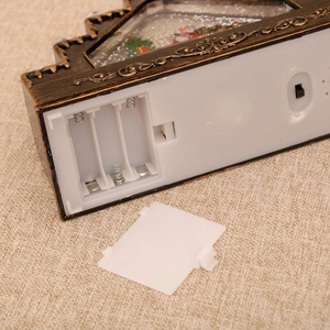 Detailed base view of Christmas lantern showing the battery compartment and power switch