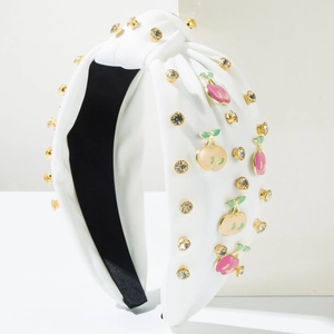 Detail of white knotted headband with cherry enamel pendants and sparkling rhinestones