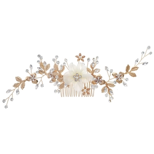 Elegant bridal hair comb with white fabric flower, pearls and gold leaves on white background