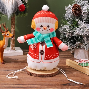 Detail of Christmas snowman drawstring gift bag with soft velvet texture and snowflake patterns