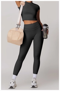 Close-up of black high-waisted yoga leggings and crop top with premium brushed texture
