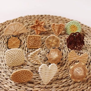 Detailed overhead view of assorted woven rattan napkin rings in heart and star shapes