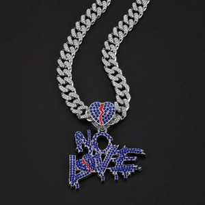 Detail of Cuban chain necklace with NO LOVE letter pendant and blue rhinestones