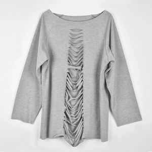 Detail of grey knitted sweatshirt with artistic vertical cutout design on front