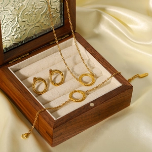 Hammered gold circle jewelry set including necklace, bracelet and earrings in a wooden box