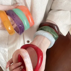 Colorful retro geometric resin bangles in multiple vibrant candy colors with marble effect