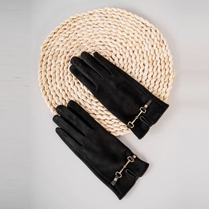 Detail of black suede gloves for women with elegant gold horsebit metal buckle decoration