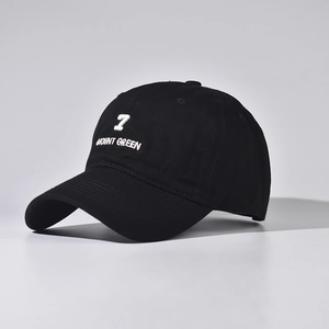 Detailed view of white embroidery on black cotton baseball cap with 3D number seven