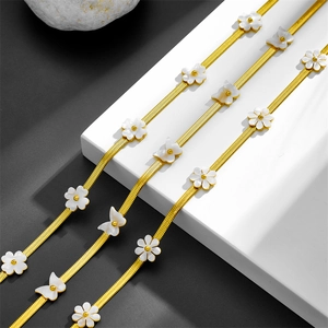 Elegant gold snake chain necklace featuring white shell butterfly and floral pendants