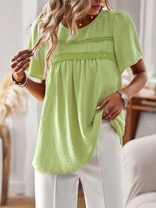Detail showing the Swiss dot texture and lace trim on this loose green blouse