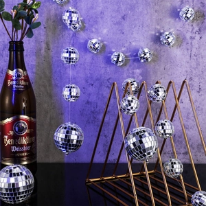 Disco mirror ball ornaments set with a golden triangle stand on a purple retro background