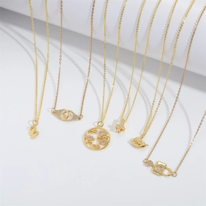 Golden multi-pendant necklace set with butterfly, cross and snail charms on white background