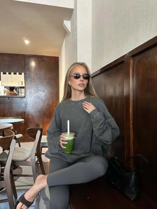 American vintage washed grey sweatshirt and yoga pants set worn by model in a cafe