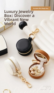 Mini round leather jewelry box with zipper and hook, showing black, white and brown colors