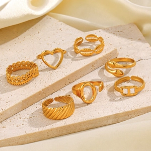Set of seven vintage golden stainless steel open rings with heart and snake designs