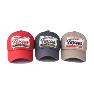 Close-up of vintage Texas embroidered patches on washed cotton baseball caps in three colors