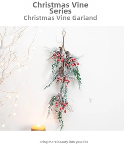 Close-up of snowy Christmas pine garland with red berries and pinecones decoration