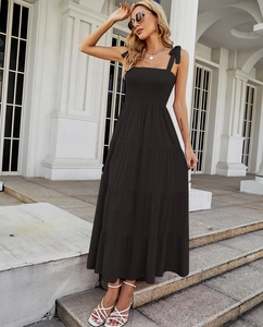 Detail view of the tiered black maxi dress with a smocked bodice and elegant straps
