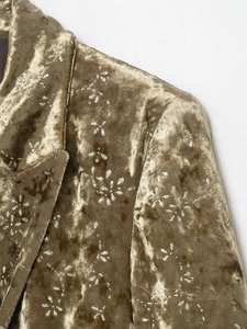 Detail of metallic velvet blazer featuring collar design and silver floral print patterns