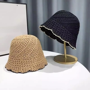 Detailed close-up of handmade crochet hollow sun hats in black and khaki woven texture