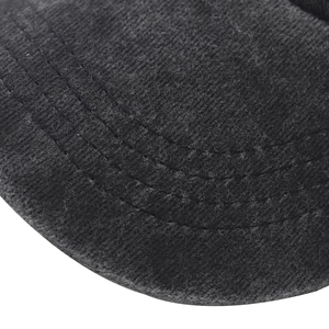 Close-up of the parallel stitching and brushed cotton texture on a dark baseball cap brim