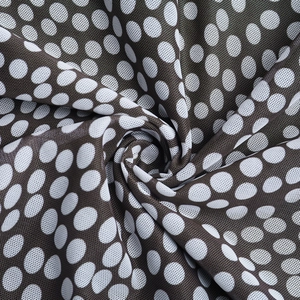 Close-up of square neck polka dot dress fabric showing breathable mesh texture and drape