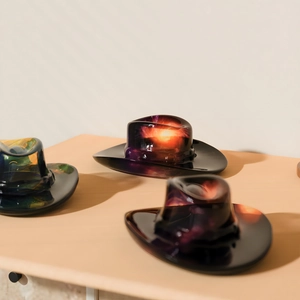 Detailed view of colorful translucent cowboy hat resin crafts with nebula swirl patterns