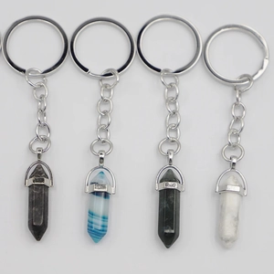 Macro detail of four hexagonal crystal stone keychains with silver metal finish